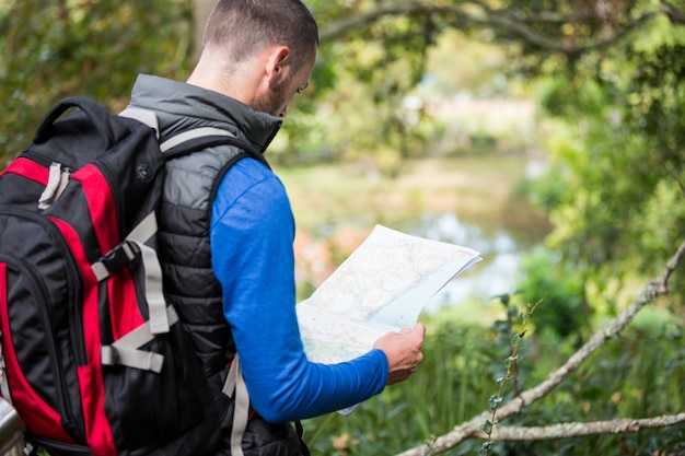 Male hiker looking at map