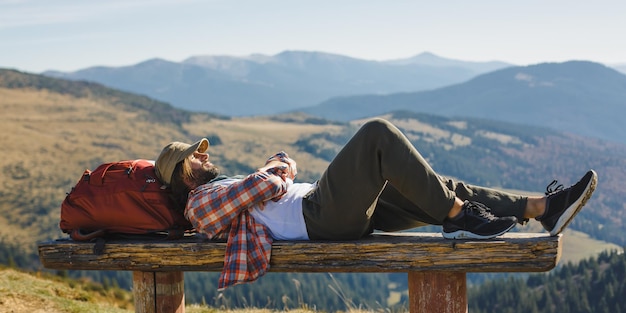 Male hiker resting on top of the mountain