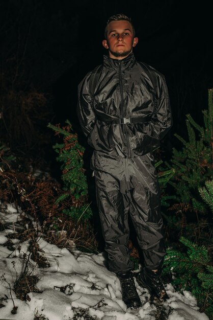 Male hikers in clothes for hiking and flashlights on winter mountain at night