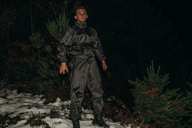 Male hikers in clothes for hiking and flashlights on winter mountain at night