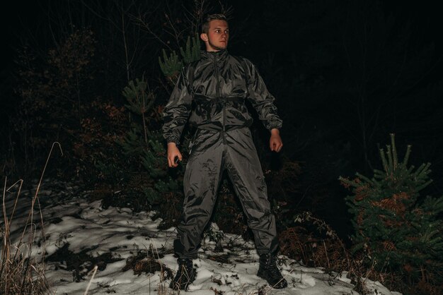 Male hikers in clothes for hiking and flashlights on winter mountain at night