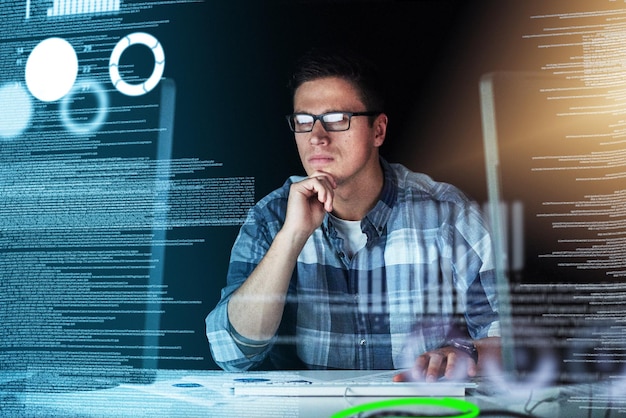 Male IT computer engineer working on a futuristic hologram or cgi screen at his office desk Tech designer working on technology to test new and innovative data Web developer work on a digital code