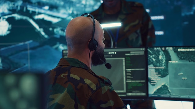 Male IT specialist operating on reconnaissance system to transmit real time data