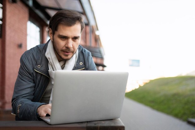 Male it worker working on laptop outside