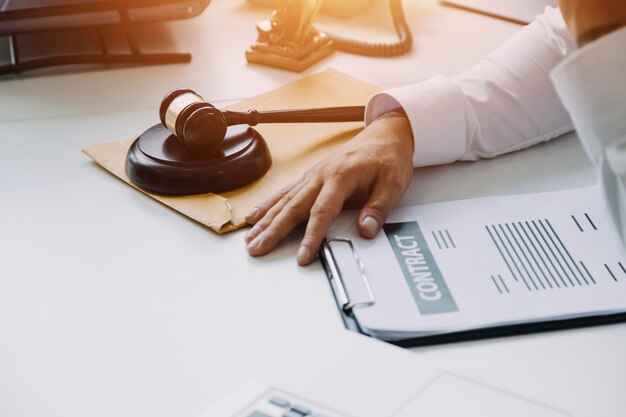 Male lawyer working with contract papers and wooden gavel on tabel in courtroom justice and law attorney court judge concept