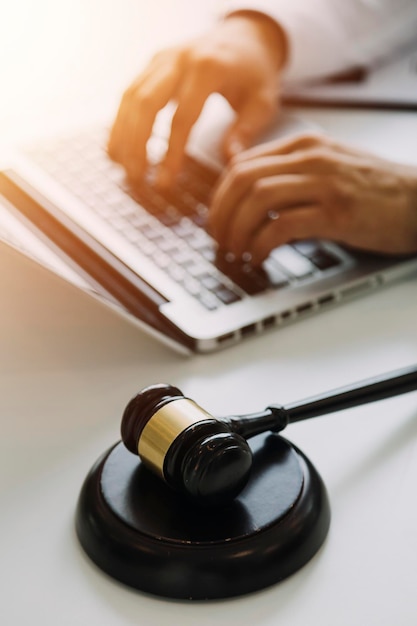 Male lawyer working with contract papers and wooden gavel on tabel in courtroom justice and law attorney court judge concept