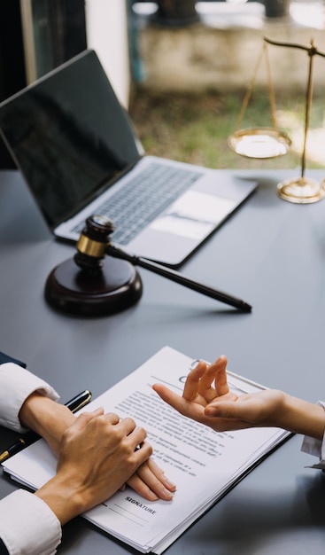 Male lawyer working with contract papers and wooden gavel on tabel in courtroom justice and law attorney court judge concept