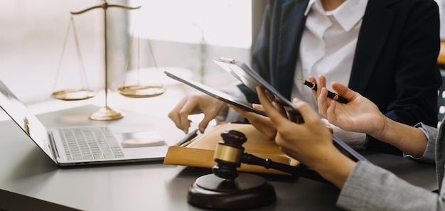 Male lawyer working with contract papers and wooden gavel on tabel in courtroom justice and law attorney court judge concept