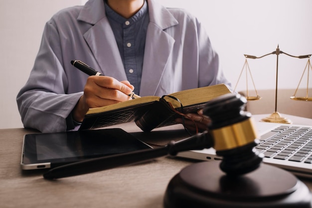 Male lawyer working with contract papers and wooden gavel on tabel in courtroom justice and law attorney court judge concept