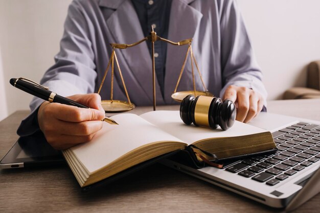 Male lawyer working with contract papers and wooden gavel on tabel in courtroom justice and law attorney court judge concept