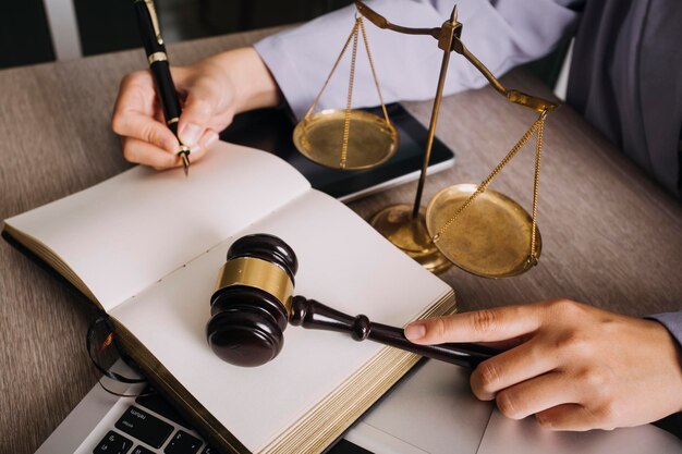 Male lawyer working with contract papers and wooden gavel on tabel in courtroom justice and law attorney court judge concept