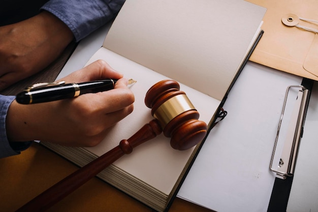 Male lawyer working with contract papers and wooden gavel on tabel in courtroom justice and law attorney court judge concept