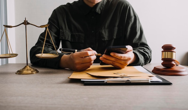 Male lawyer working with contract papers and wooden gavel on tabel in courtroom justice and law attorney court judge concept