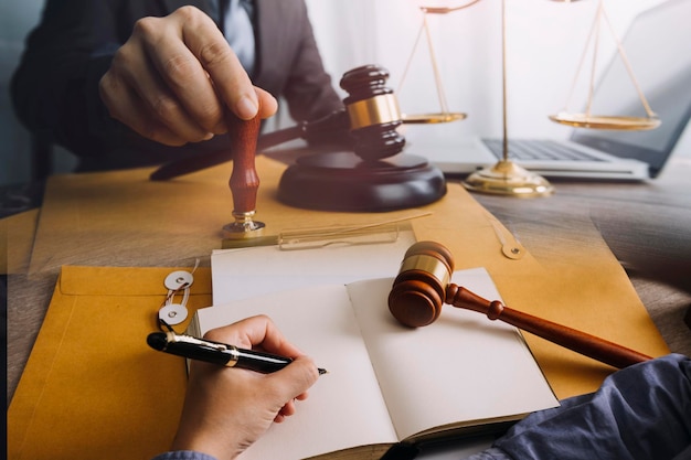 Male lawyer working with contract papers and wooden gavel on tabel in courtroom justice and law attorney court judge concept