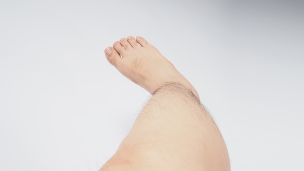 Male legs and barefoot is isolated on white background.