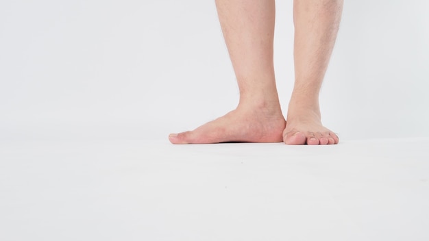 Male legs and barefoot is isolated on white background.