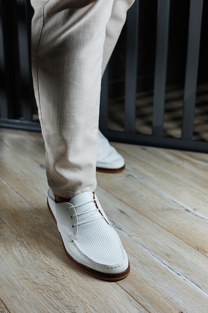 Male legs in leather summer shoes Comfortable men's white moccasins without laces Casual men's moccasins