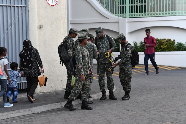 MALE, MALDIVES - FEBRUARY 17 2018 - People and children in island main place before evening pray time