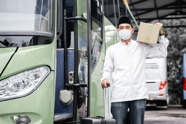 Male muslim travel by public bus during pandemic wearing mask