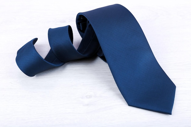 Male necktie on wooden table background