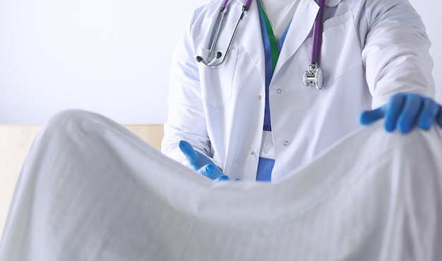 Male obstetrician and scrubs nurse are delivered to the pregnant woman in the delivery room of the hospital