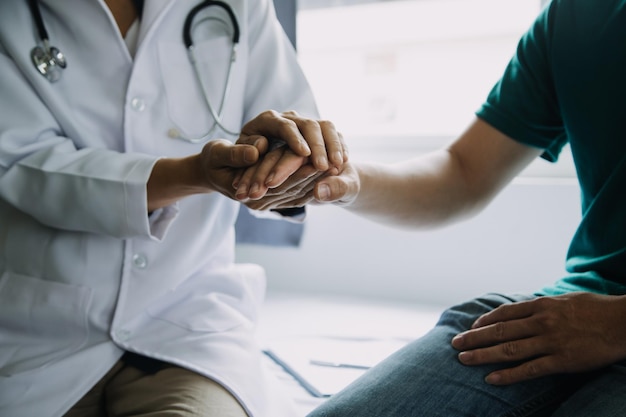 Male patient having consultation with doctor or psychiatrist who working on diagnostic examination on men's health disease or mental illness in medical clinic or hospital mental health service center