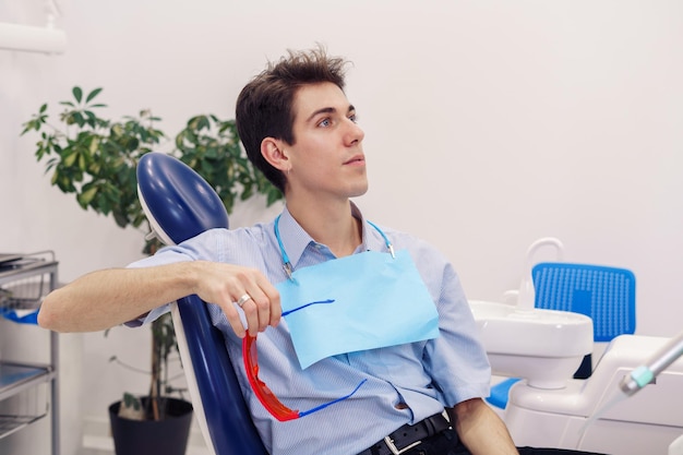 Male patient sitting on dental chair