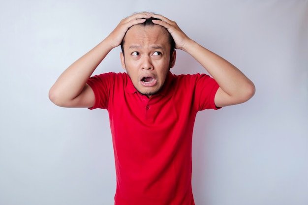 Male pattern hair loss problem concept Young Asian man worried about balding Baldness alopecia in males