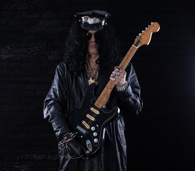 male portrait of heavy metal rock musician with electric guitar