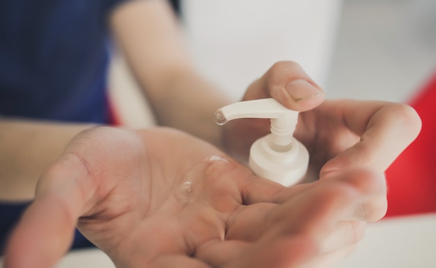 Male pouring alcohol-based sanitize on hands