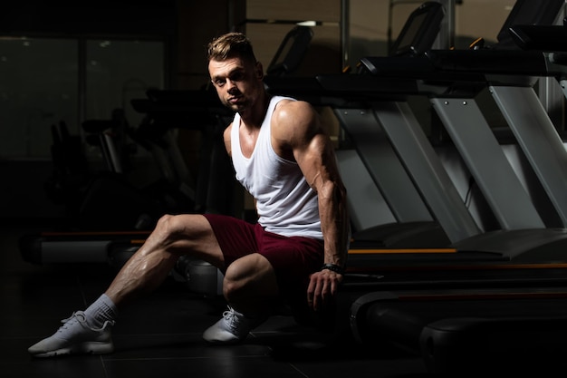 Male Resting On Bench In Fitness Center