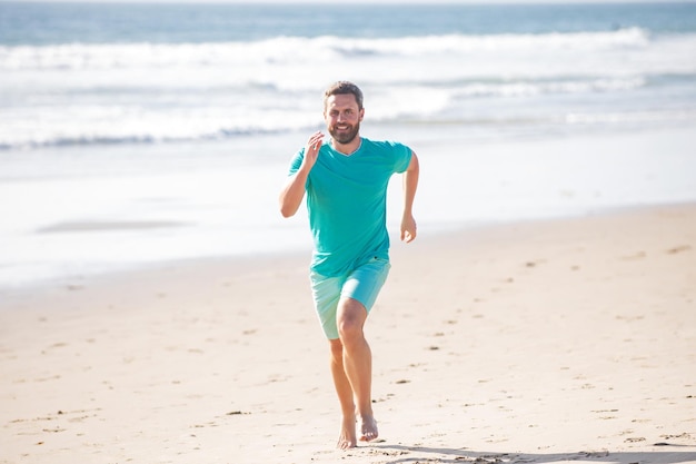 Male runner athlete run on sandy beach Man running