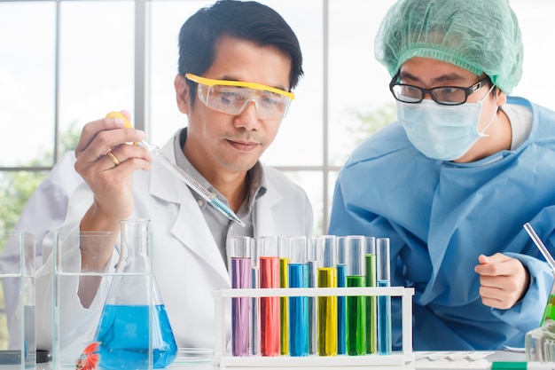 Male scientist team working with color Glass Beaker test tube 