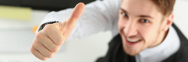 Male showing thumbs up sign with hand cheerful office worker