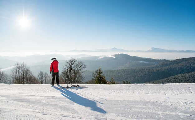 Male skier on top of the ski slope