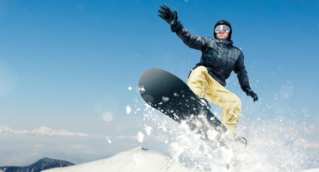 Male snowboarder, dangerous downhill in action