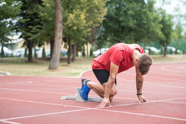 Male Sprinter Getting Ready to Start the Race