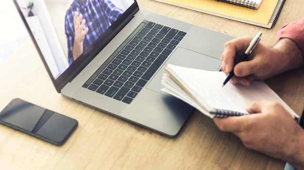 Male student studying online using laptop