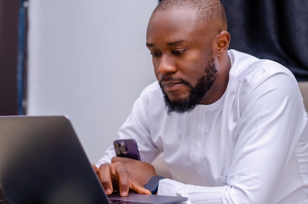 Male student working on laptop at home