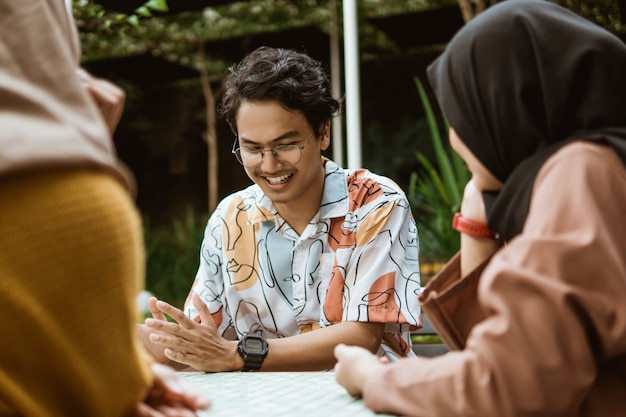 Male students smile chatting while hanging out