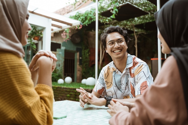 Male students smile chatting while hanging out