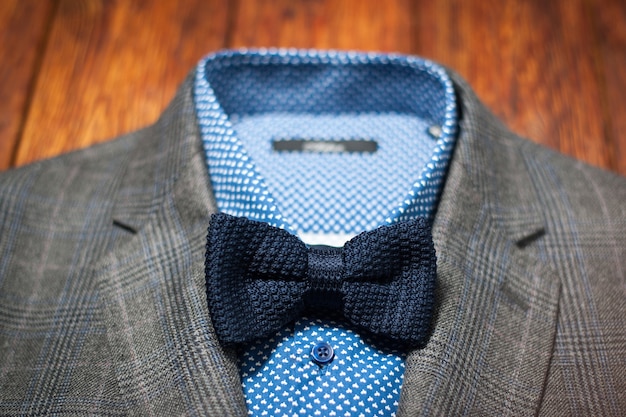 Male suit set. Man checked jacket blue shirt bow tie