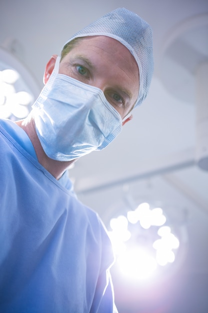 Male surgeon wearing surgical mask