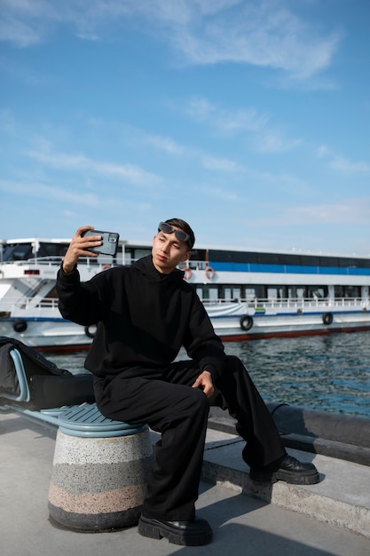 Male tourist taking selfie with smartphone while traveling