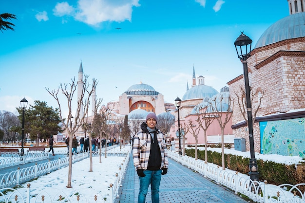 Male tourist visiting hagia sophia man smiling in front of turkey most popular mosque attraction