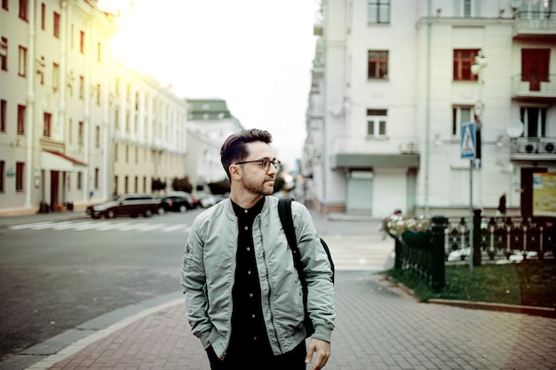 male traveler walks around the old city and studies the classical architecture of Europe