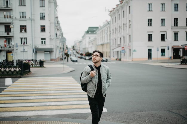 male traveler walks around the old city and studies the classical architecture of Europe