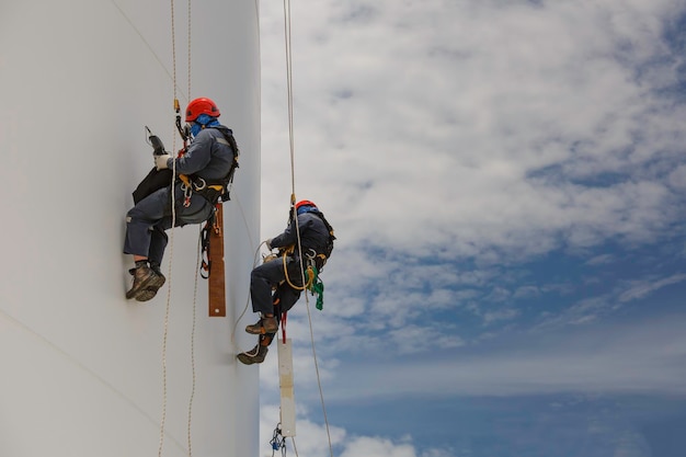 Male two workers down height tank rope access inspection of thickness shell plate storage tank