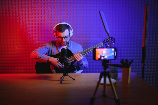 Male vlogger recording music related broadcast at studio