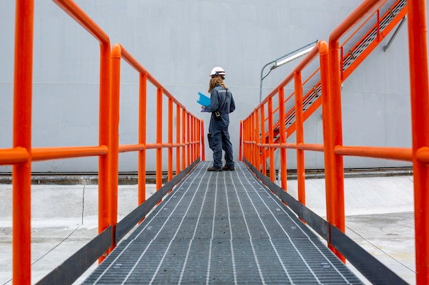 Male walking the stairway inspection visual in factory tank